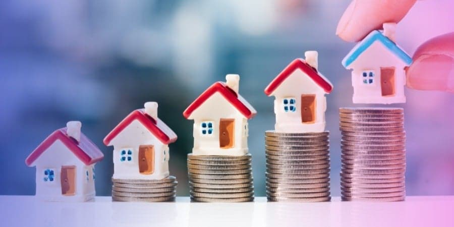 houses stacked on coins