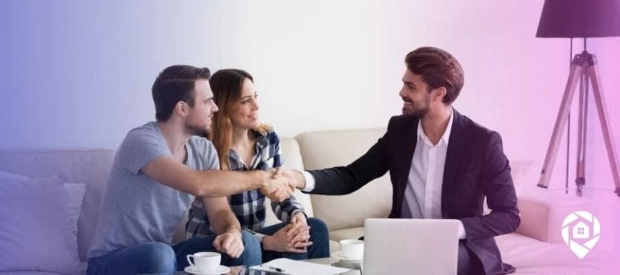 Real estate investor couple meeting with lender to discuss property funding options and financing strategies.