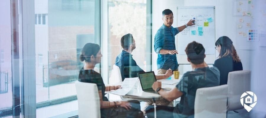 Successful real estate investor providing real estate investment advice during a team meeting.