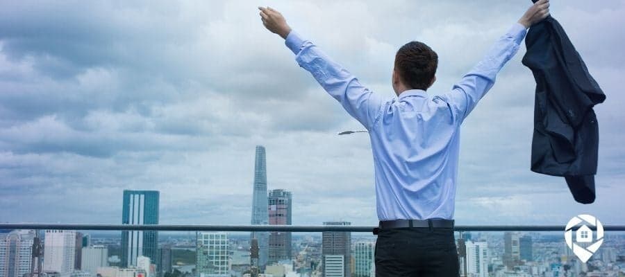 Man celebrating financial freedom after leaving corporate job for real estate investing