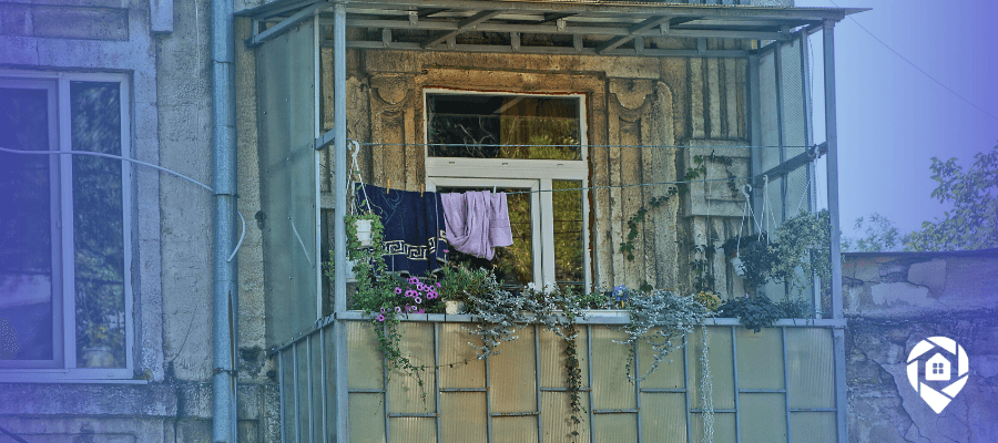 Older apartment building with an enclosed balcony, the kind of long-held home that enters pre-probate real estate.