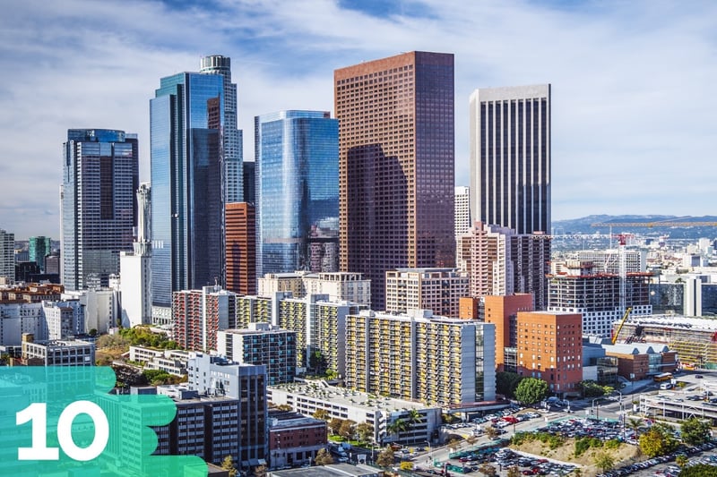 Downtown Los Angeles featuring a variety of office buildings and skyscrapers together with mountains in the distance.