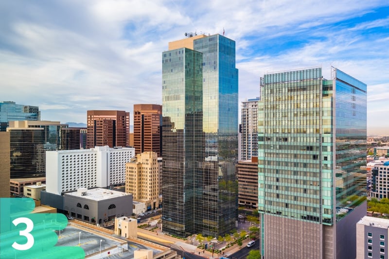 Aerial shot of downtown Phoenix, Arizona skyscrapers in the heart of the city with bright blue cloudy skies.