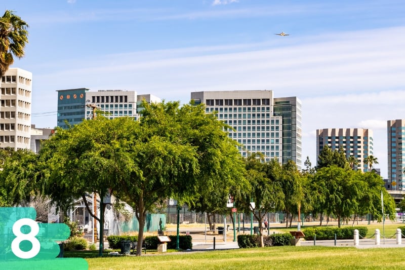 Park in San Diego featuring basketball courts, and skyscrapers in the background on a beautiful sunny day.