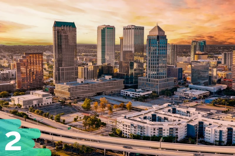 Overview of downtown Tampa area with a focus on skyscraper buildings and cars driving along the highways.